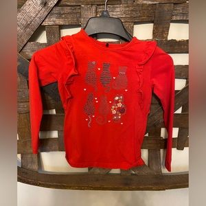 Red cat ruffle shirt.
